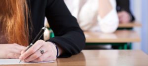 Students writing an exam at university, horizontal